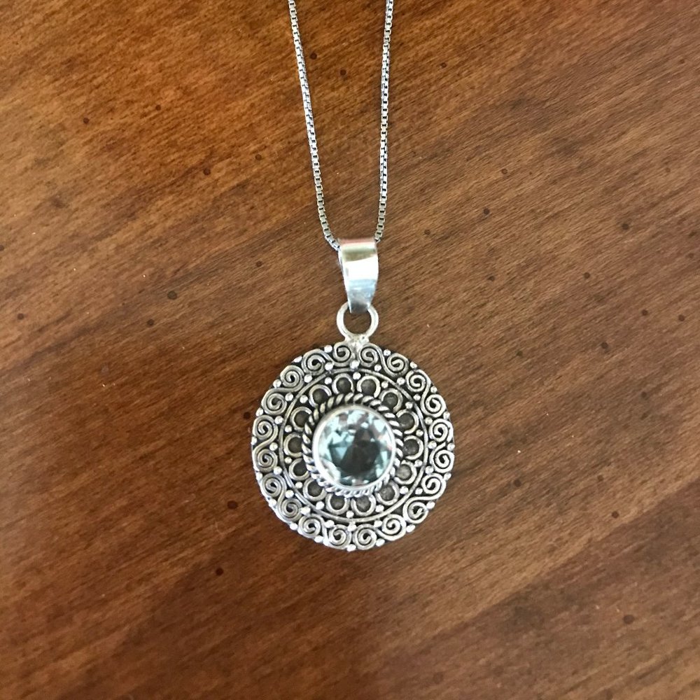 Handcrafted sterling silver and blue topaz pendant